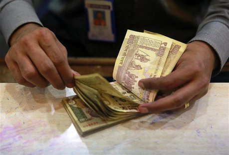 A cashier counts Indian rupee currency notes inside a bank in Mumbai in this August 5, 2013 file photo. REUTERS/Danish Siddiqui/Files A cashier counts Indian rupee currency notes inside a bank in Mumbai in this August 5, 2013 file photo. REUTERS/Danish Siddiqui/Files