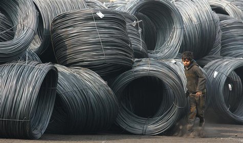 Deepak, 13, the child of a labourer, runs besides stacked rolls of iron coil at a railway yard in the northern Indian city of Chandigarh Jan Deepak, 13, the child of a labourer, runs besides stacked rolls of iron coil at a railway yard in the northern Indian city of Chandigarh Jan