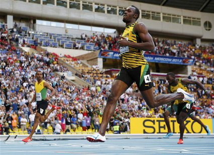 Usain Bolt of Jamaica (R) crosses the finish line to win the men's 200 metres final ahead of teammate Warren Weir (L) during the IAAF World Usain Bolt of Jamaica (R) crosses the finish line to win the men's 200 metres final ahead of teammate Warren Weir (L) during the IAAF World