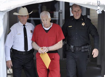 Jerry Sandusky (C) leaves the Centre County Courthouse after his sentencing in his child sex abuse case in Bellefonte, Pennsylvania October Jerry Sandusky (C) leaves the Centre County Courthouse after his sentencing in his child sex abuse case in Bellefonte, Pennsylvania October