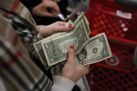 A customer counts her money while waiting in line to check out at a Target store in Torrington, Connecticut November 25, 2011. REUTERS/Jessi A customer counts her money while waiting in line to check out at a Target store in Torrington, Connecticut November 25, 2011. REUTERS/Jessi
