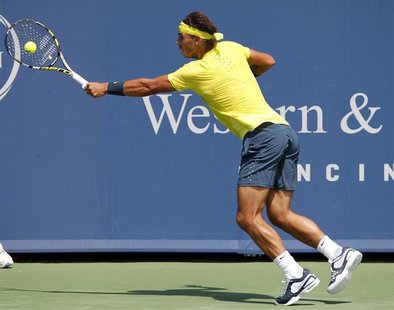 Rafael Nadal of Spain hits a return ball to John Isner of the U.S. during their championship match at the men's Cincinnati Open tennis tourn Rafael Nadal of Spain hits a return ball to John Isner of the U.S. during their championship match at the men's Cincinnati Open tennis tourn