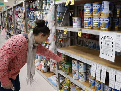 A woman browses for milk powder at a stand with a food recall notice from Nutricia in a supermarket in Huntly, Waikato Region in New Zealand A woman browses for milk powder at a stand with a food recall notice from Nutricia in a supermarket in Huntly, Waikato Region in New Zealand