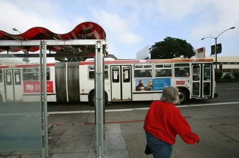 A passenger walks to catch a bus at a solar powered bus stop in San Francisco, California November 4, 2009. REUTERS/Robert Galbraith A passenger walks to catch a bus at a solar powered bus stop in San Francisco, California November 4, 2009. REUTERS/Robert Galbraith