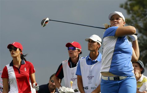 Caroline Hedwall of Team Europe tees off of the 15th as opponent Michelle Wie of Team USA (L) watches in the singles matches of their 2013 S Caroline Hedwall of Team Europe tees off of the 15th as opponent Michelle Wie of Team USA (L) watches in the singles matches of their 2013 S