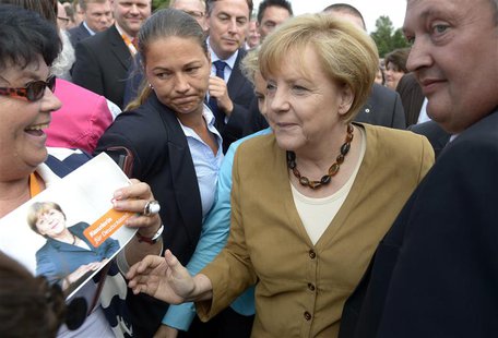 German Chancellor Angela Merkel (CDU) (C) is welcomed by supporters as she arrives at an election campaign in Cloppenburg, August 17, 2013. German Chancellor Angela Merkel (CDU) (C) is welcomed by supporters as she arrives at an election campaign in Cloppenburg, August 17, 2013.