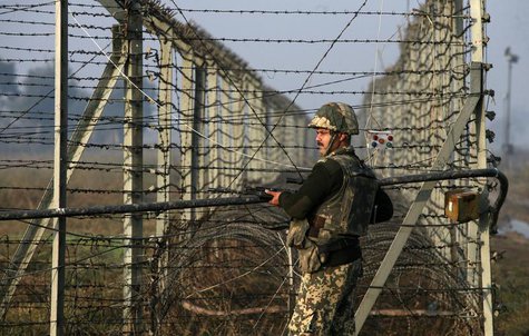 An Indian Border Security Force (BSF) soldier patrols near the fenced border with Pakistan in Suchetgarh, southwest of Jammu January 11, 201 An Indian Border Security Force (BSF) soldier patrols near the fenced border with Pakistan in Suchetgarh, southwest of Jammu January 11, 201