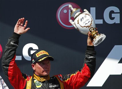 Lotus F1 Formula One driver Kimi Raikkonen of Finland holds up his trophy on the podium after placing second in the Hungarian F1 Grand Prix Lotus F1 Formula One driver Kimi Raikkonen of Finland holds up his trophy on the podium after placing second in the Hungarian F1 Grand Prix