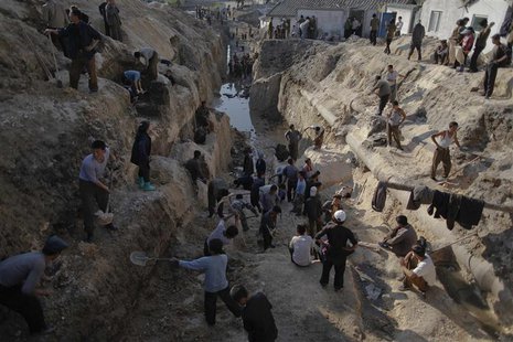 North Korean students and volunteers work to repair a water supply system in Haeju, capital of the South Hwanghae province hit by recent flo North Korean students and volunteers work to repair a water supply system in Haeju, capital of the South Hwanghae province hit by recent flo
