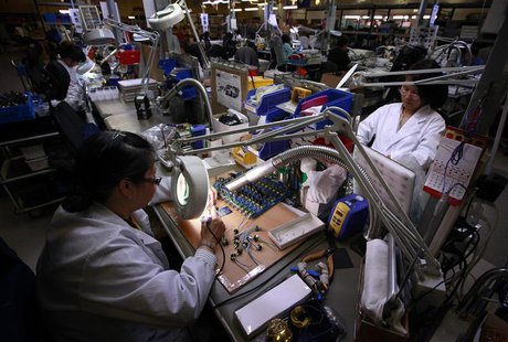 Workers use magnifying glasses as they work on components at the Rode Microphone factory located in western Sydney August 15, 2013. REUTERS/ Workers use magnifying glasses as they work on components at the Rode Microphone factory located in western Sydney August 15, 2013. REUTERS/