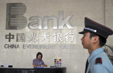 A security personnel on duty stands next to the reception desk at a branch of China Everbright Bank in Hefei, Anhui province August 18, 2010 A security personnel on duty stands next to the reception desk at a branch of China Everbright Bank in Hefei, Anhui province August 18, 2010