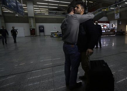 U.S. journalist Glenn Greenwald (front L) embraces his partner David Miranda upon his arrival at Rio de Janeiro's International Airport Augu U.S. journalist Glenn Greenwald (front L) embraces his partner David Miranda upon his arrival at Rio de Janeiro's International Airport Augu