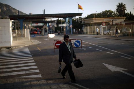 A man leaves the British territory of Gibraltar at its border with Spain, in la Linea de la Concepcion, southern Spain August 19, 2013. REUT A man leaves the British territory of Gibraltar at its border with Spain, in la Linea de la Concepcion, southern Spain August 19, 2013. REUT