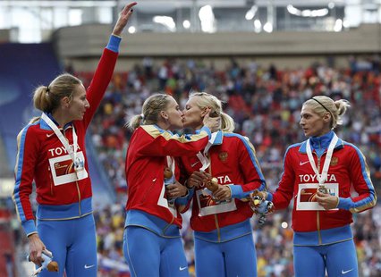 Gold medallists team Russia kiss and celebrate at the women's 4x400 metres relay victory ceremony during the IAAF World Athletics Championsh Gold medallists team Russia kiss and celebrate at the women's 4x400 metres relay victory ceremony during the IAAF World Athletics Championsh