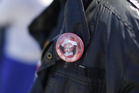 A man wears a pin in support of inmates who are participating in a state-wide prisoner hunger strike demanding an end to indefinite solitary A man wears a pin in support of inmates who are participating in a state-wide prisoner hunger strike demanding an end to indefinite solitary