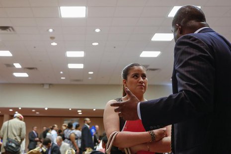A woman stands with her paperwork as she speaks with a recruiter while attending a job fair in New York, June 11, 2013. REUTERS/Lucas Jackso A woman stands with her paperwork as she speaks with a recruiter while attending a job fair in New York, June 11, 2013. REUTERS/Lucas Jackso