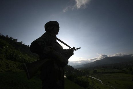 An Indian army soldier stands guard while patrolling near the Line of Control, a ceasefire line dividing Kashmir between India and Pakistan, An Indian army soldier stands guard while patrolling near the Line of Control, a ceasefire line dividing Kashmir between India and Pakistan,