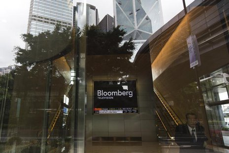 A man stands in front of a screen showing broadcasts of Bloomberg Channel at Hong Kong's financial Central district May 15,2013. REUTERS/Tyr A man stands in front of a screen showing broadcasts of Bloomberg Channel at Hong Kong's financial Central district May 15,2013. REUTERS/Tyr
