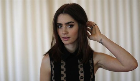 Cast member Lily Collins poses for a portrait while promoting her upcoming movie "The Mortal Instruments: City of Bones" in Los Angeles, Cal Cast member Lily Collins poses for a portrait while promoting her upcoming movie "The Mortal Instruments: City of Bones" in Los Angeles, Cal