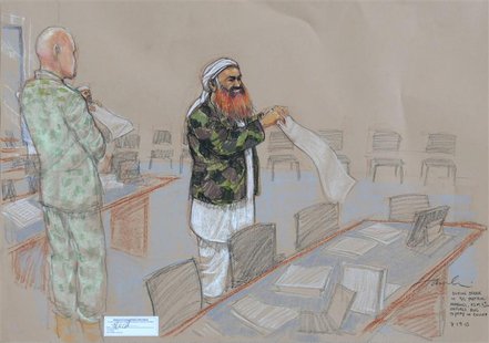 In this photo of a sketch by courtroom artist Janet Hamlin and reviewed by the U.S. Department of Defense, Khalid Sheikh Mohammed unfurls a In this photo of a sketch by courtroom artist Janet Hamlin and reviewed by the U.S. Department of Defense, Khalid Sheikh Mohammed unfurls a