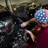 A mechanic checks the engine of an Indian motorcycle at the showroom of Indian Motorcycles of Northern New Jersey in Union, August 20, 2013. A mechanic checks the engine of an Indian motorcycle at the showroom of Indian Motorcycles of Northern New Jersey in Union, August 20, 2013.