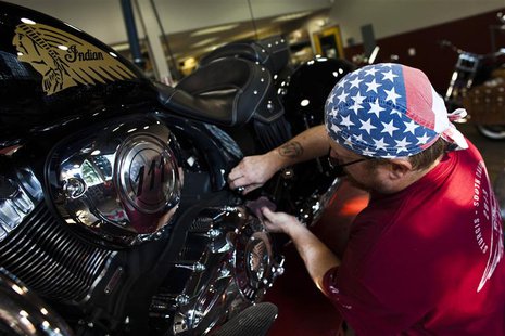A mechanic checks the engine of an Indian motorcycle at the showroom of Indian Motorcycles of Northern New Jersey in Union, August 20, 2013. A mechanic checks the engine of an Indian motorcycle at the showroom of Indian Motorcycles of Northern New Jersey in Union, August 20, 2013.