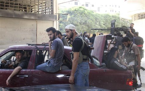 Free Syrian Army fighters carry their weapons and sit in cars and pick-up trucks near the frontline in the refugee camp of Yarmouk, near Dam Free Syrian Army fighters carry their weapons and sit in cars and pick-up trucks near the frontline in the refugee camp of Yarmouk, near Dam