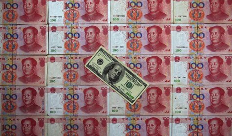 A U.S. $100 banknote is placed on top of 100 yuan banknotes in this picture illustration taken in Beijing May 7, 2013. REUTERS/Petar Kujundz A U.S. $100 banknote is placed on top of 100 yuan banknotes in this picture illustration taken in Beijing May 7, 2013. REUTERS/Petar Kujundz