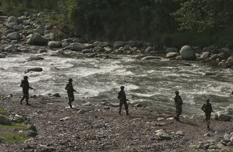 Indian Border Security Force (BSF) soldiers patrol next to a stream near the Line of Control (LoC), a ceasefire line dividing Kashmir betwee Indian Border Security Force (BSF) soldiers patrol next to a stream near the Line of Control (LoC), a ceasefire line dividing Kashmir betwee