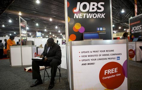 A job-seeker completes an application at a career fair held by civil rights organization National Urban League as part of its annual confere A job-seeker completes an application at a career fair held by civil rights organization National Urban League as part of its annual confere