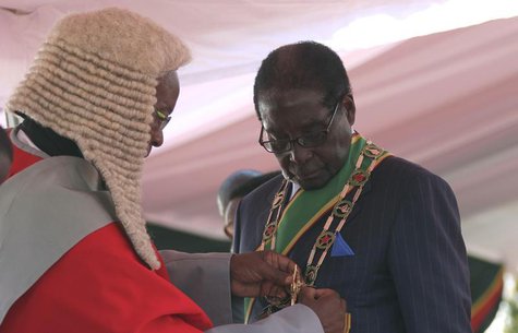Zimbabwe President Robert Mugabe is sworn in during his inauguration as President, in Harare August 22, 2013. REUTERS/Philimon Bulawayo Zimbabwe President Robert Mugabe is sworn in during his inauguration as President, in Harare August 22, 2013. REUTERS/Philimon Bulawayo