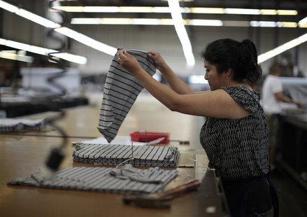 A worker cuts a clothing pattern at the Karen Kane clothing company in Los Angeles, California June 30, 2011. REUTERS/Lucy Nicholson A worker cuts a clothing pattern at the Karen Kane clothing company in Los Angeles, California June 30, 2011. REUTERS/Lucy Nicholson