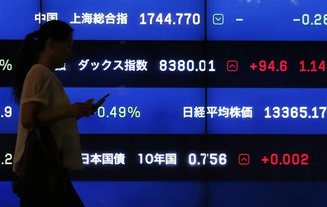A woman walks past a screen showing market indices in Tokyo August 22, 2013. REUTERS/Issei Kato A woman walks past a screen showing market indices in Tokyo August 22, 2013. REUTERS/Issei Kato