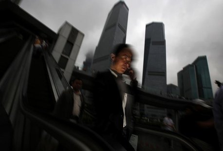 A businessman talks on his mobile phone as he walks in the financial area of Pudong in Shanghai May 30, 2013. REUTERS/Carlos Barria A businessman talks on his mobile phone as he walks in the financial area of Pudong in Shanghai May 30, 2013. REUTERS/Carlos Barria