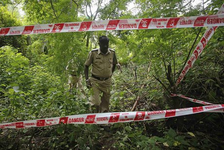 Policemen survey the crime scene where a photo journalist was raped inside an abandoned textile mill in Mumbai August 23, 2013. REUTERS/Dani Policemen survey the crime scene where a photo journalist was raped inside an abandoned textile mill in Mumbai August 23, 2013. REUTERS/Dani