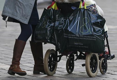 A shopper leaves a Marks & Spencer store in Leicester, central England March 18, 2013. REUTERS/Darren Staples A shopper leaves a Marks & Spencer store in Leicester, central England March 18, 2013. REUTERS/Darren Staples
