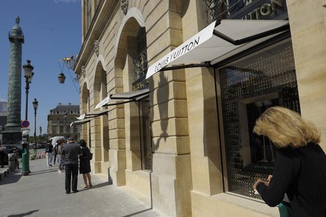 A woman walks past the LVMH's Louis Vuitton's jewellery store on Place Vendome during its opening day in Paris July 2, 2012. REUTERS/Philipp A woman walks past the LVMH's Louis Vuitton's jewellery store on Place Vendome during its opening day in Paris July 2, 2012. REUTERS/Philipp