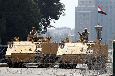 Egyptian soldiers stand guard as they close one of the entrances to Tahrir Square in Cairo August 23, 2013. REUTERS/Muhammad Hamed Egyptian soldiers stand guard as they close one of the entrances to Tahrir Square in Cairo August 23, 2013. REUTERS/Muhammad Hamed