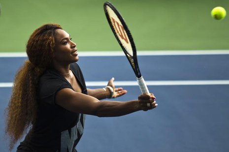 Serena Williams of the U.S. returns a ball while she attends an exhibition game after the Draw Ceremony before the start of the 2013 U.S. Op Serena Williams of the U.S. returns a ball while she attends an exhibition game after the Draw Ceremony before the start of the 2013 U.S. Op