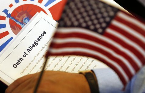 The Oath of Allegiance is held next to an American flag during a Special Naturalization Ceremony for 30 U.S. citizen candidates in the Cash The Oath of Allegiance is held next to an American flag during a Special Naturalization Ceremony for 30 U.S. citizen candidates in the Cash
