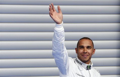 Mercedes Formula One driver Lewis Hamilton of Britain waves as he celebrates taking pole position after the qualifying session for the Belgi Mercedes Formula One driver Lewis Hamilton of Britain waves as he celebrates taking pole position after the qualifying session for the Belgi