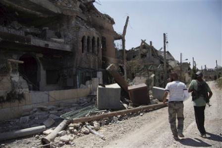 Free Syrian Army fighters walk past damaged buildings and debris in Deir al-Zor August 20, 2013. Picture taken August 20, 2013. REUTERS/Khalil Ashawi Free Syrian Army fighters walk past damaged buildings and debris in Deir al-Zor August 20, 2013. Picture taken August 20, 2013. REUTERS/Khalil Ashawi