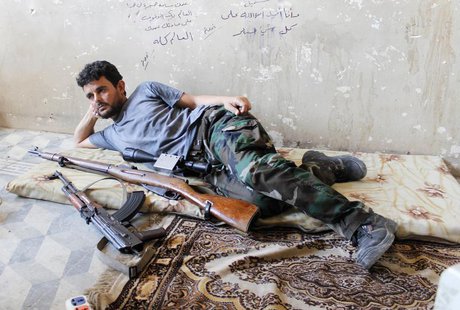 A Free Syrian Army fighter rests next to his weapons in al-Swaika district in Aleppo August 24, 2013. REUTERS/Molhem Barakat A Free Syrian Army fighter rests next to his weapons in al-Swaika district in Aleppo August 24, 2013. REUTERS/Molhem Barakat
