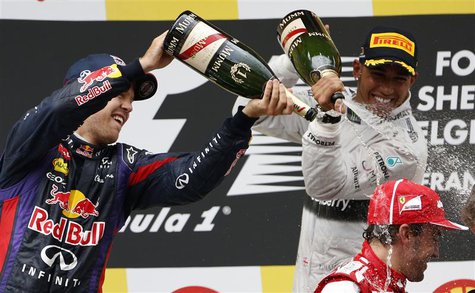 Winner Red Bull Formula One driver Sebastian Vettel of Germany (L) and third-placed Mercedes Formula One driver Lewis Hamilton of Britain (b Winner Red Bull Formula One driver Sebastian Vettel of Germany (L) and third-placed Mercedes Formula One driver Lewis Hamilton of Britain (b