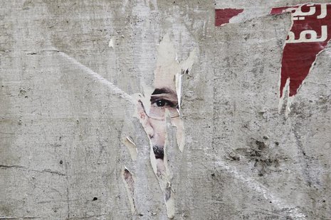 Remnants of a poster of ousted Egyptian President Mohamed Mursi are pictured on a wall on a street in Cairo August 25, 2013. REUTERS/Muhamma Remnants of a poster of ousted Egyptian President Mohamed Mursi are pictured on a wall on a street in Cairo August 25, 2013. REUTERS/Muhamma