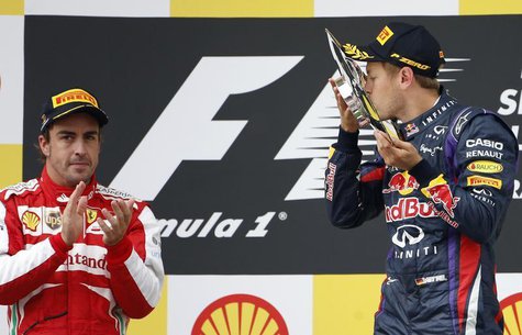 Red Bull Formula One driver Sebastian Vettel of Germany (R) celebrates winning the Belgian F1 Grand Prix beside second-placed Ferrari Formul Red Bull Formula One driver Sebastian Vettel of Germany (R) celebrates winning the Belgian F1 Grand Prix beside second-placed Ferrari Formul