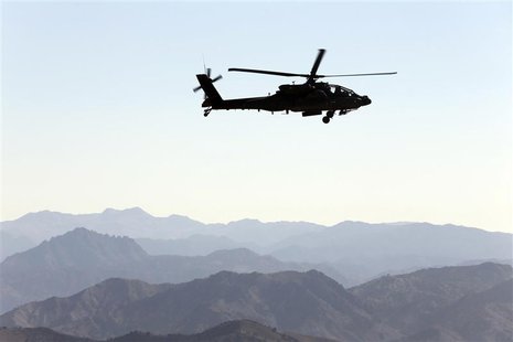 A U.S Army Apache helicopter flies near the town of Walli Was during an operation in Paktika province, near the border with Pakistan Novembe A U.S Army Apache helicopter flies near the town of Walli Was during an operation in Paktika province, near the border with Pakistan Novembe