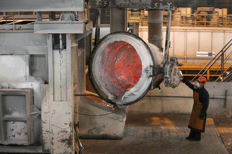 A worker operates a mixer of fused aluminium at the foundry shop of the Rusal Sayanogorsk aluminium smelter outside the town of Sayanogorsk, A worker operates a mixer of fused aluminium at the foundry shop of the Rusal Sayanogorsk aluminium smelter outside the town of Sayanogorsk,