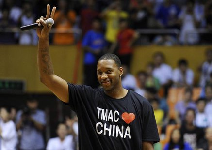 NBA basketball player Tracy McGrady of Detroit Pistons gestures to his fans at a stadium during a promotional event of his China tour in Hef NBA basketball player Tracy McGrady of Detroit Pistons gestures to his fans at a stadium during a promotional event of his China tour in Hef