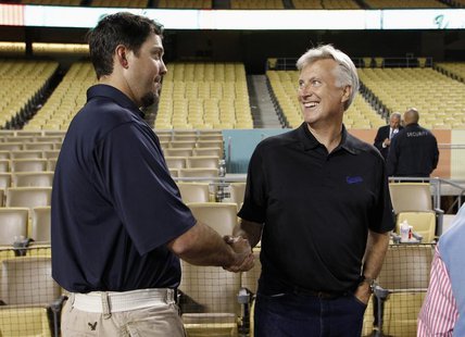 Chairman and owner of the Los Angeles Dodgers Mark Walter (R) shakes hands with Dodgers pitcher Josh Beckett (L) during a news conference fo Chairman and owner of the Los Angeles Dodgers Mark Walter (R) shakes hands with Dodgers pitcher Josh Beckett (L) during a news conference fo